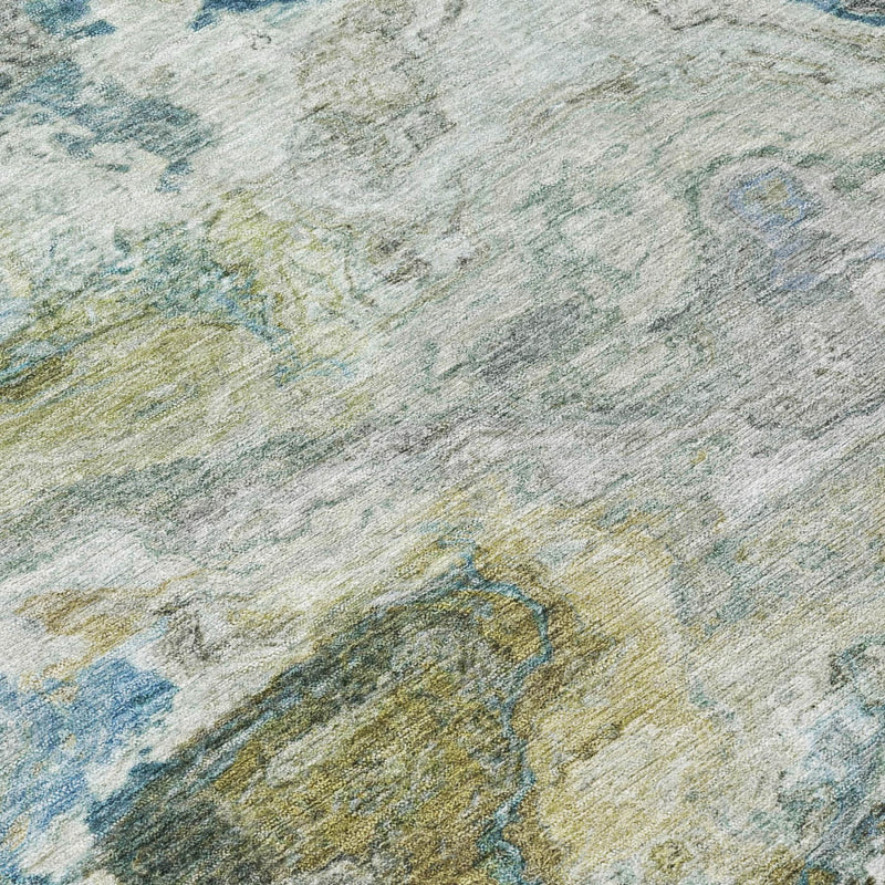 Close-up of round area rug fabric with blue, green, and cream distressed swirls