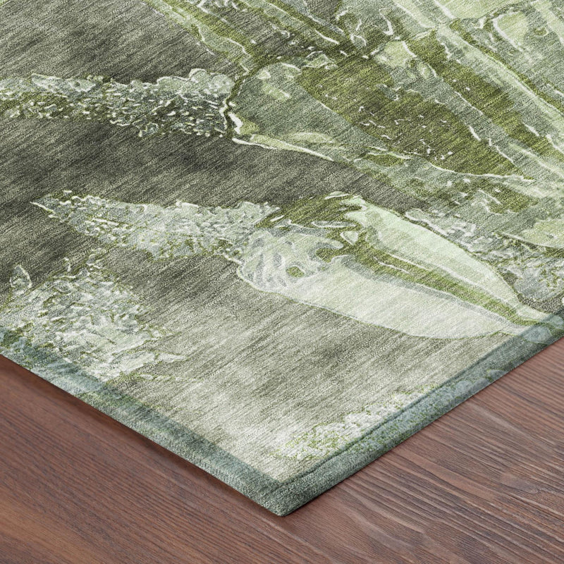 Green and silver abstract floral area rug corner with textured pattern.