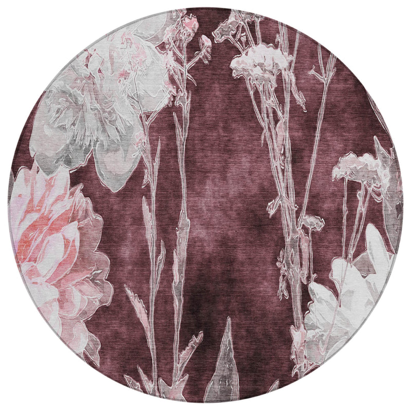 Round burgundy rug with faded white botanical floral pattern