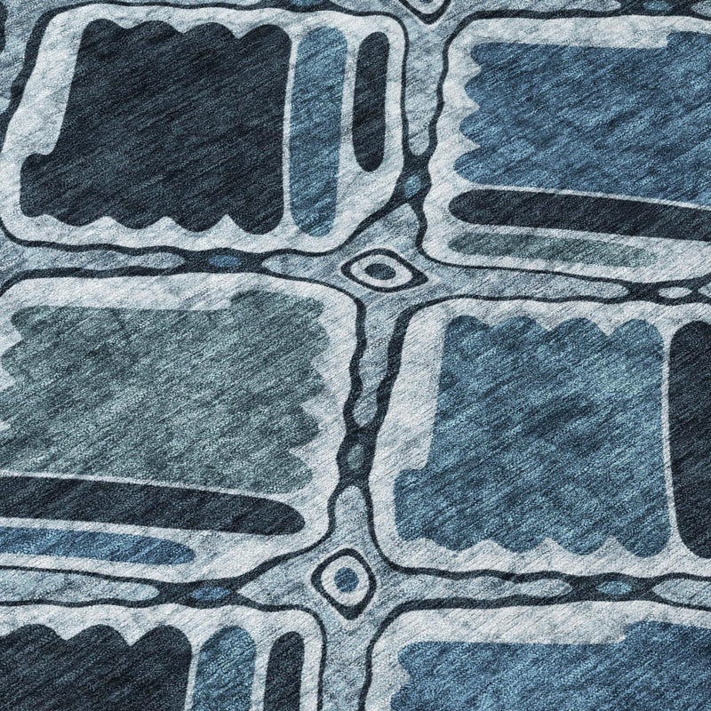 Geometric area rug texture with blue and graphite shapes and light outline details