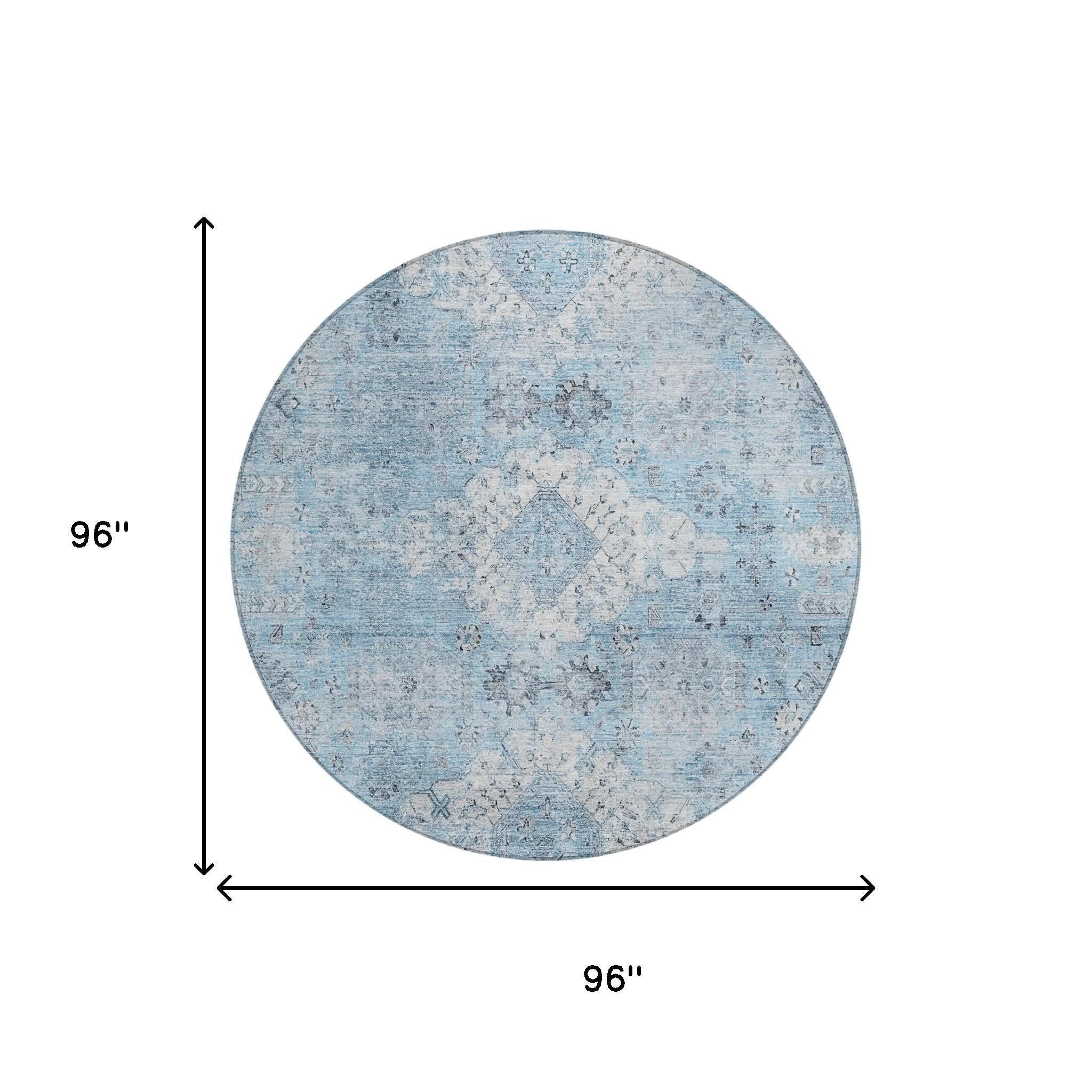 Round blue area rug, 96 inches, featuring a distressed floral pattern in soft tones, ideal for modern decor.