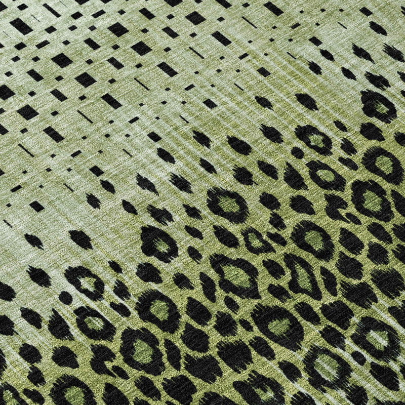 Green animal-print area rug with black spots, dashes, and geometric grid pattern