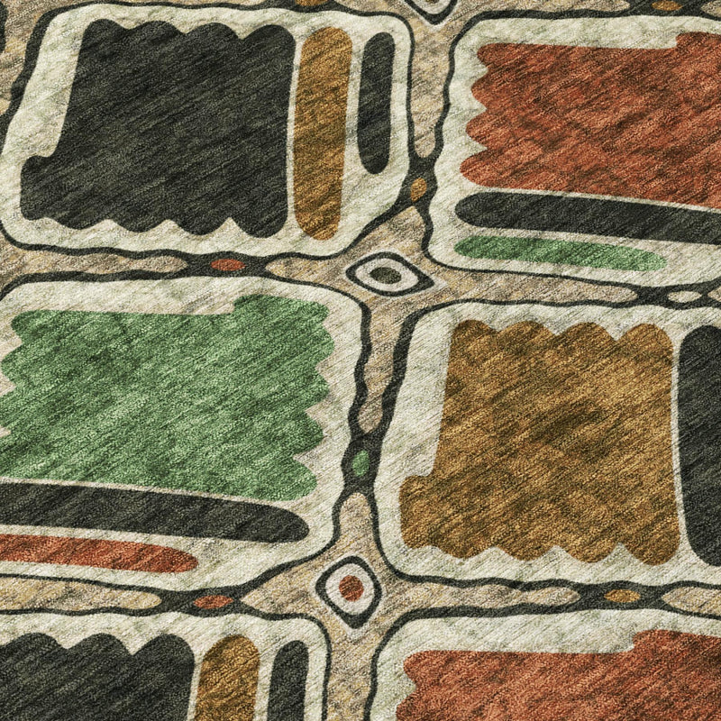 Geometric pattern area rug close-up with green, orange, brown, and dark blocks