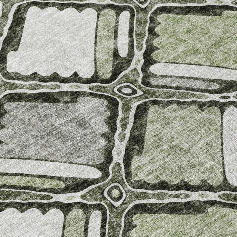Close-up of sage and gray geometric rug with white outlined blocks