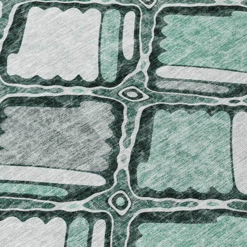 Aqua and teal geometric area rug detail with outlined blocks and textured wash effect
