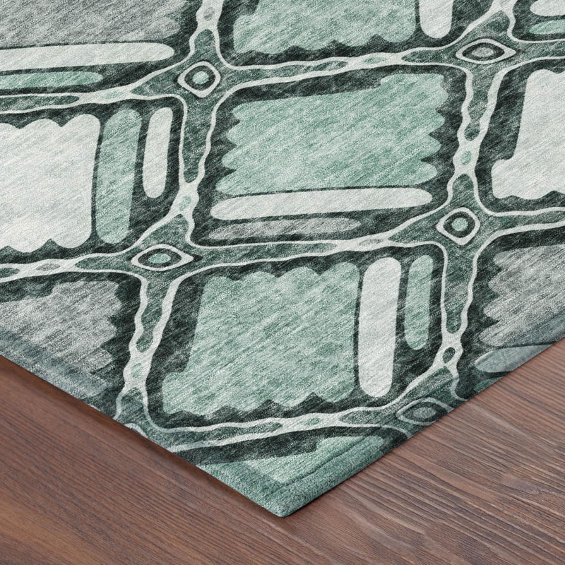 Aqua and teal geometric patterned area rug corner with outlined rectangles, washable