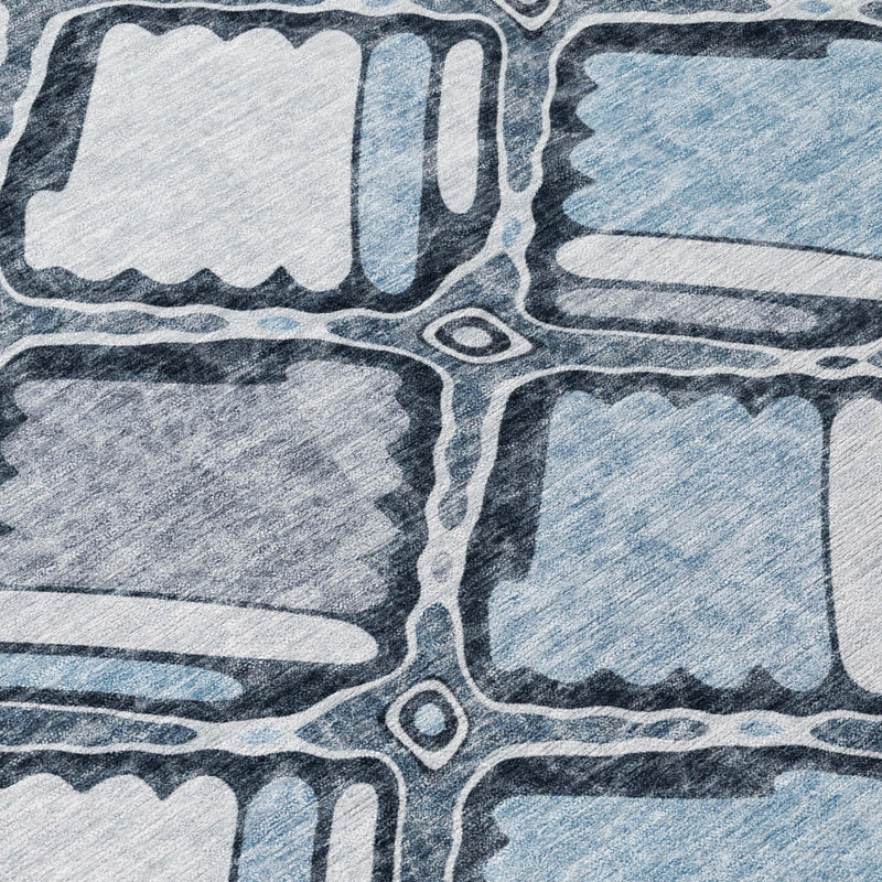 Close-up of blue and gray geometric rug pattern with outlined shapes