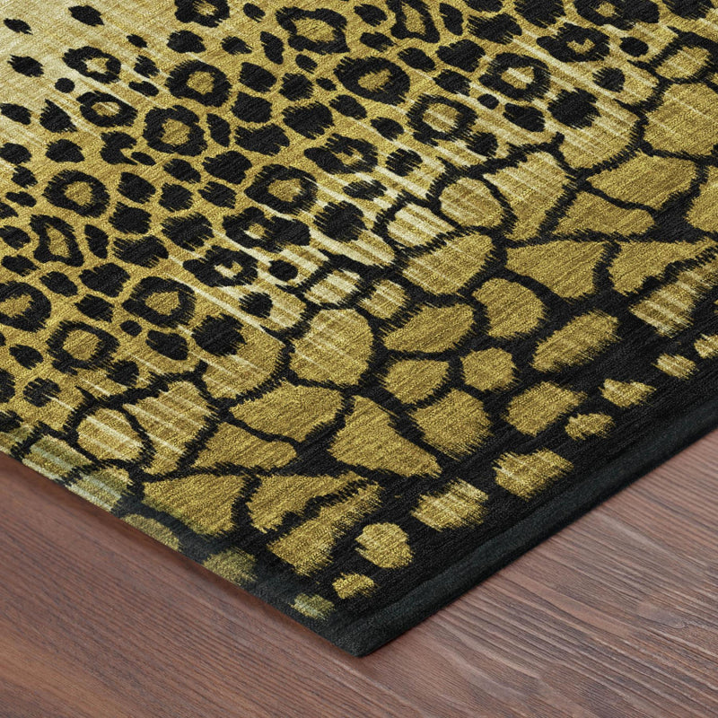 Corner of round area rug with gold and dark leopard-style print and black border edge.