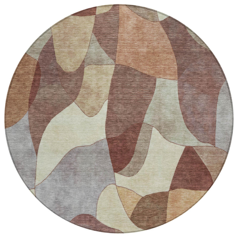 Round abstract washable area rug with geometric patchwork in beige, gray, and rust