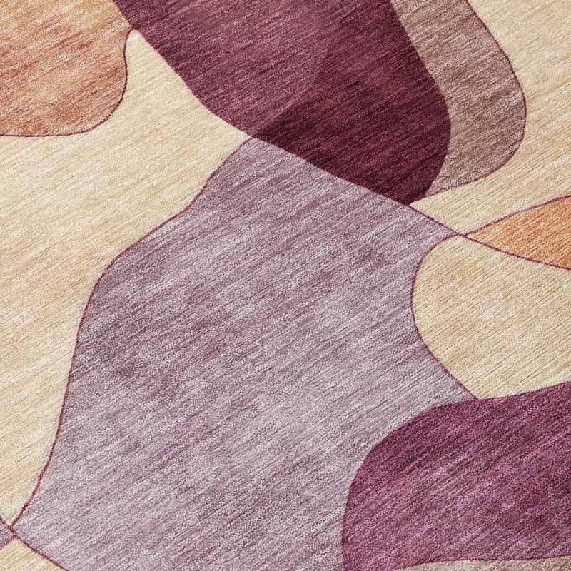 Close-up abstract rug texture with maroon, light tan, and red-toned shapes