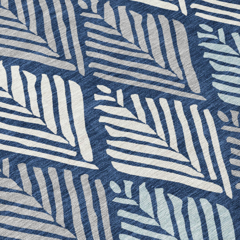 Blue and white geometric pattern area rug with stylized leaf shapes, close-up