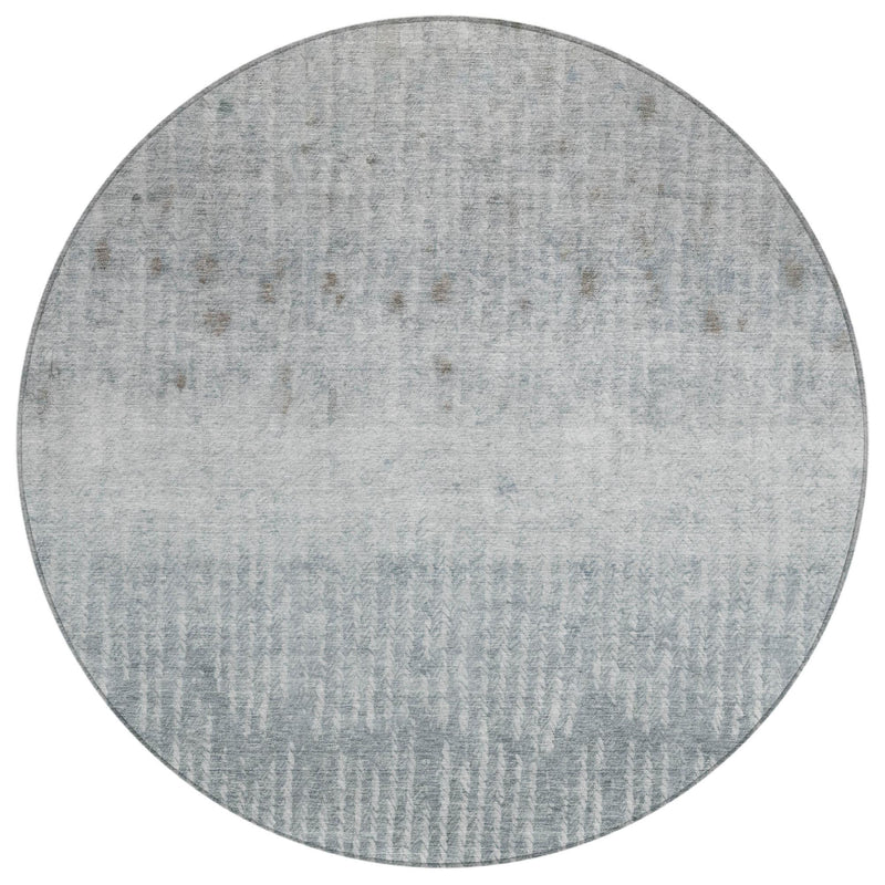 Round area rug in cool gray with subtle distressed abstract texture