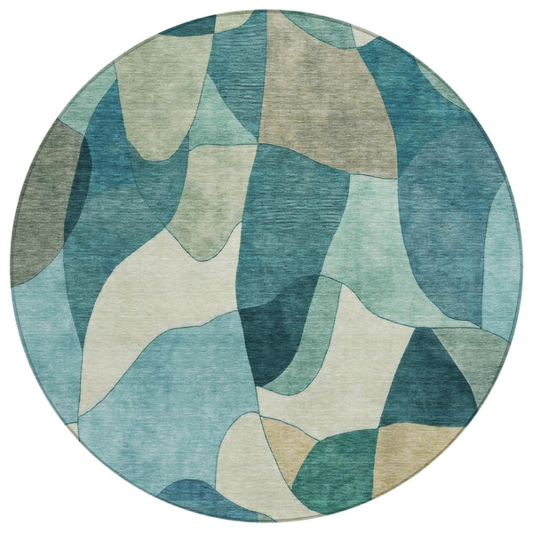 Round abstract area rug with teal, blue, and beige patchwork shapes
