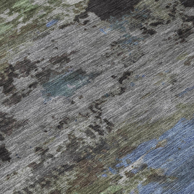 Abstract area rug close-up in gray with blue and green mottled highlights