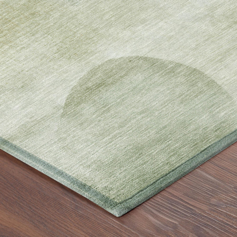 Round area rug corner detail with green border and textured woven surface