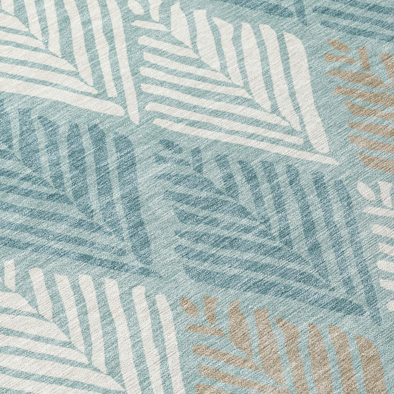 Teal blue and silver geometric leaf pattern area rug, close-up texture