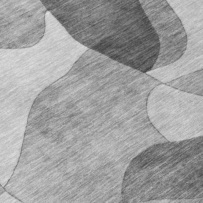 Gray and silver abstract rug pattern of overlapping geometric shapes, close-up
