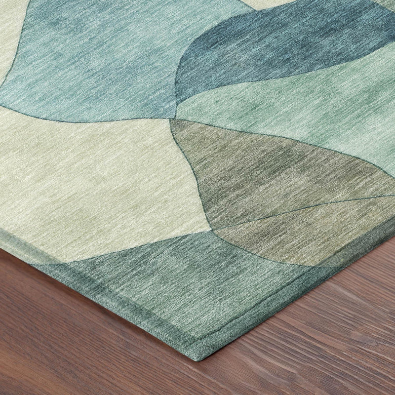 Teal, beige, and dark green abstract area rug corner with textured weave