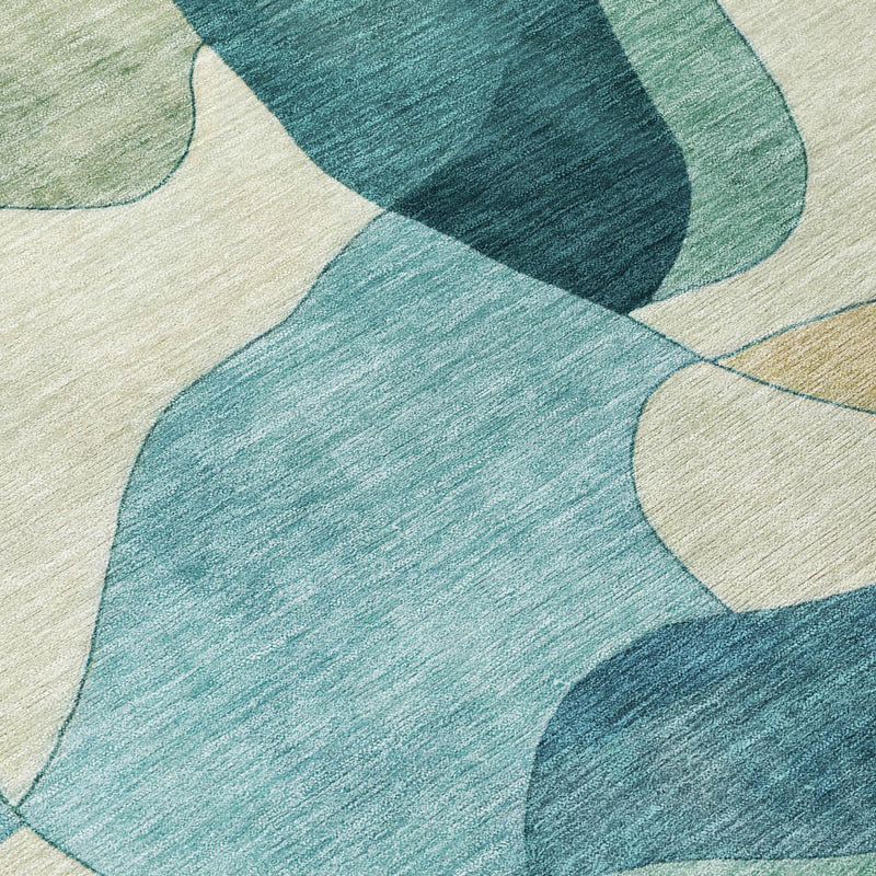Close-up of teal and beige abstract rug with textured, low-pile weave