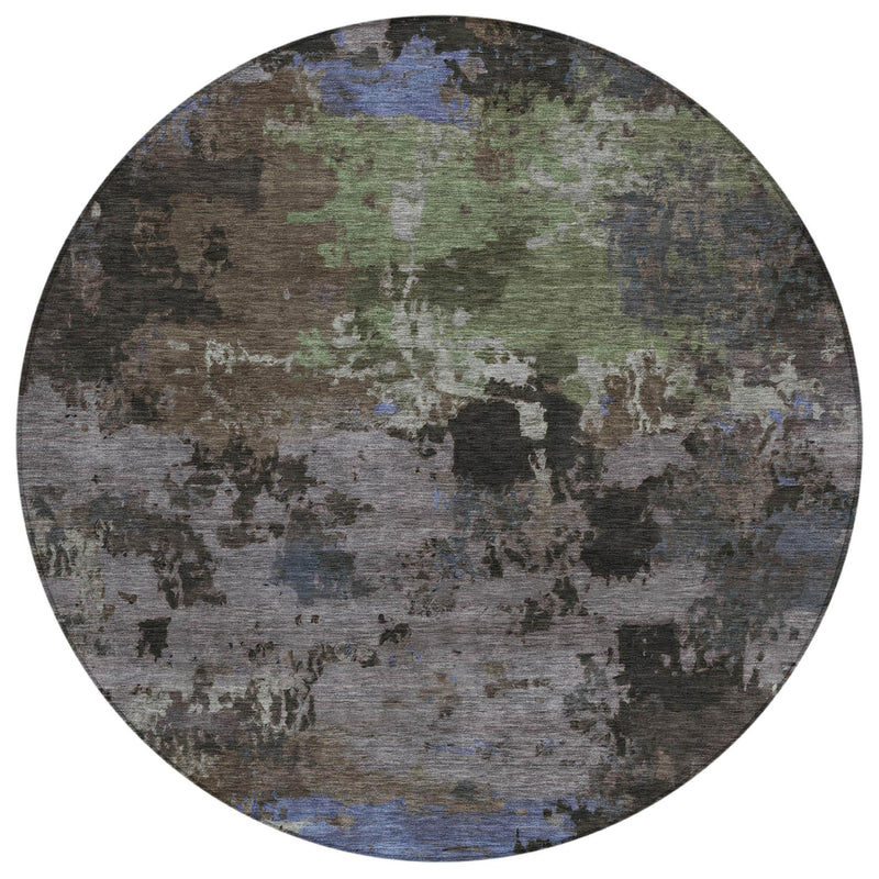 Round abstract area rug with multicolor distressed motif, blue, green, and charcoal tones.