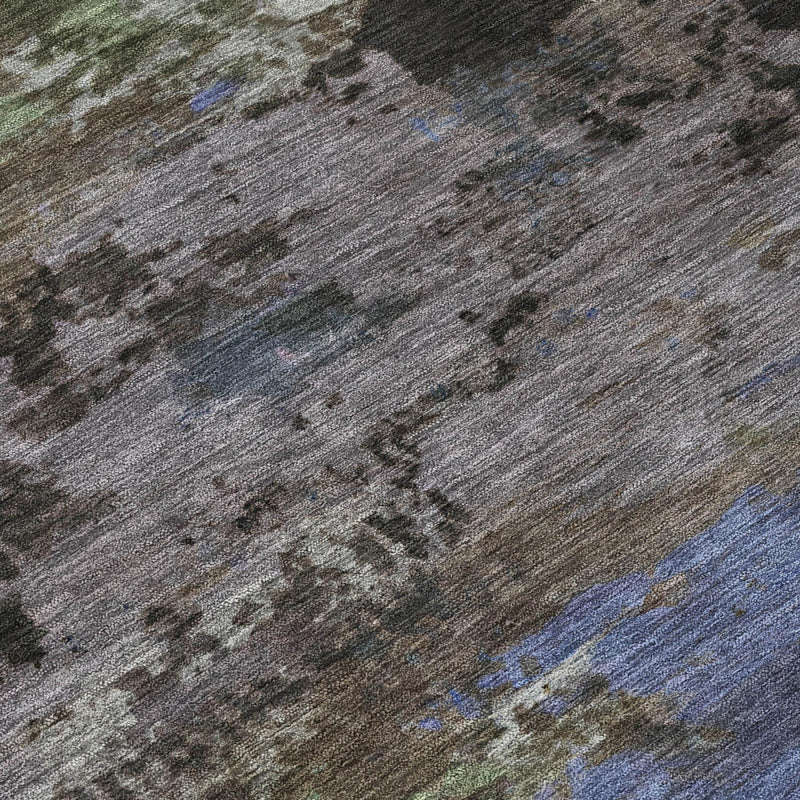 Close-up abstract rug texture in gray with blue and green flecks