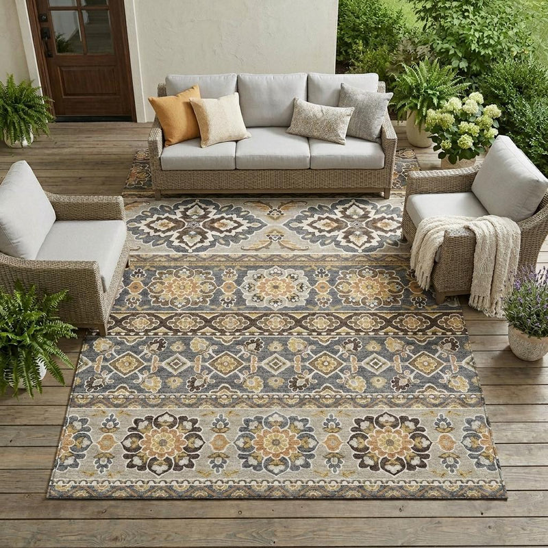 Gray and ivory area rug laid in living room with bold tribal border