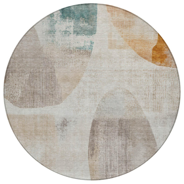 Round geometric area rug in ivory with silver, blue, and tan abstract shapes