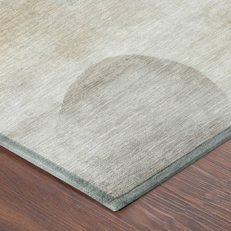 Round rug edge detail: ivory pile with teal binding and mottled silver pattern