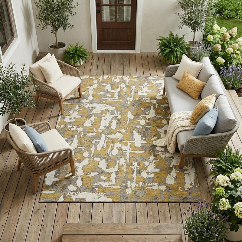 Gold and ivory abstract washable indoor/outdoor area rug on wood floor