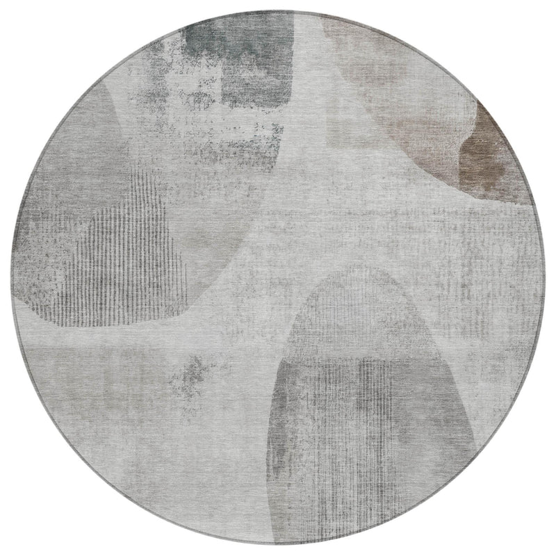 Round area rug with abstract geometric pattern in light gray and taupe