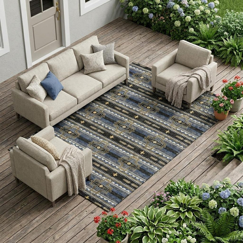 Tribal indoor outdoor area rug with blue and gold geometric pattern on deck floor