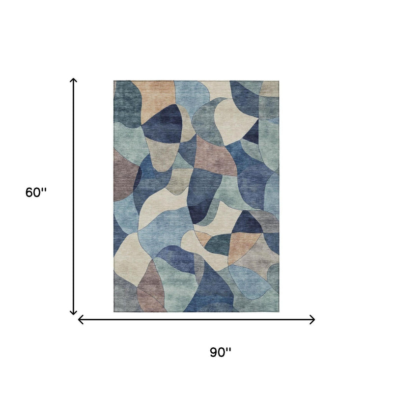 5 x 8 ft abstract area rug, blue and navy shapes on cream background