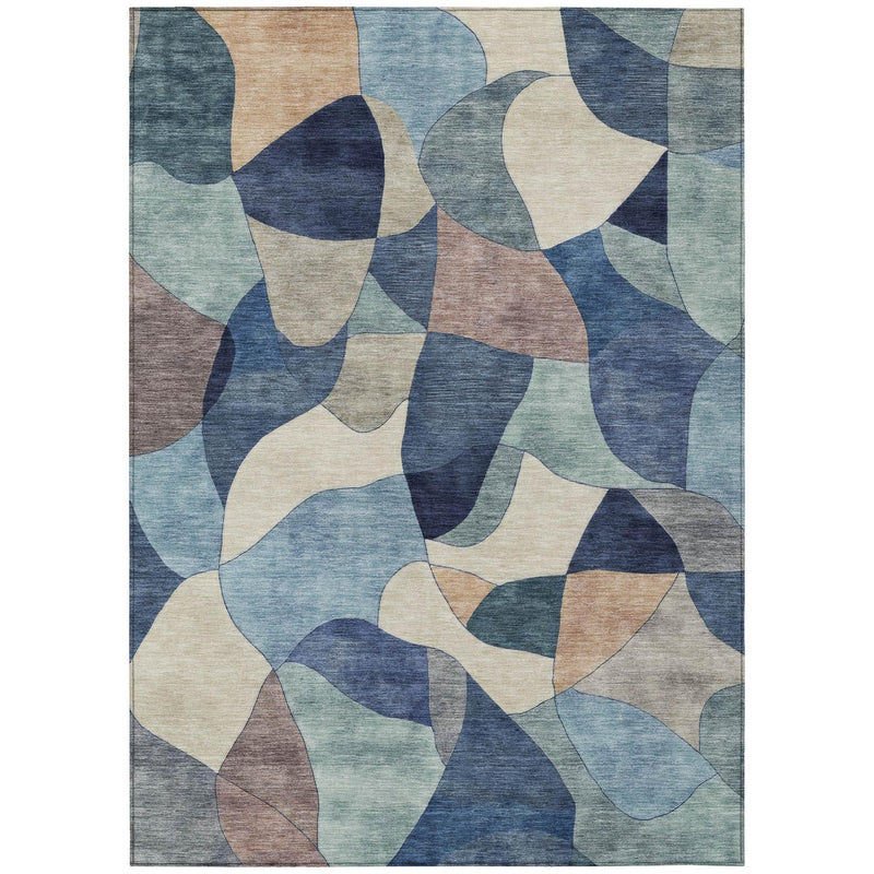 Abstract indoor/outdoor area rug with layered blue and navy curved shapes on cream