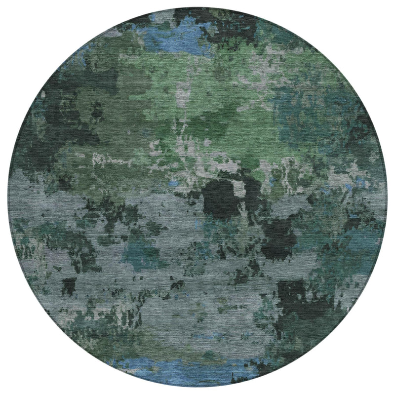 Round abstract area rug with distressed green, gray, and blue mottled pattern