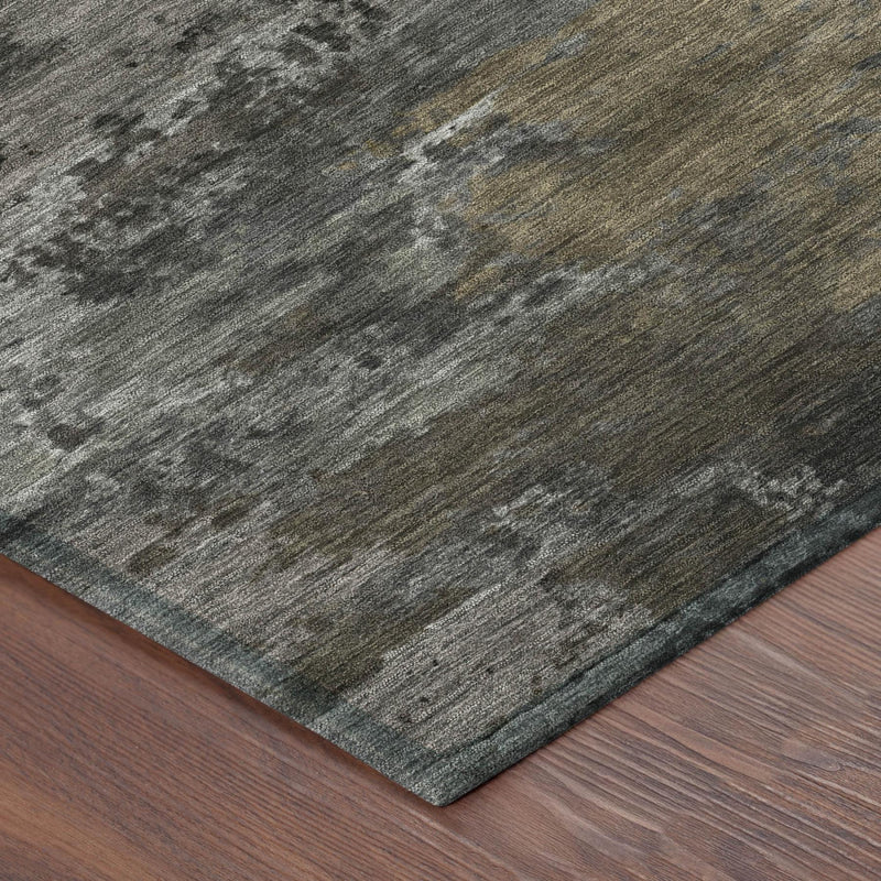 Corner close-up of abstract gray area rug with flecked texture and dark edges