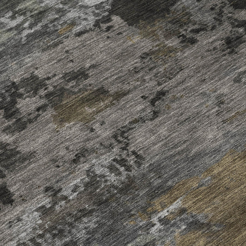 Close-up of mottled abstract rug texture in gray with small tan and olive marks