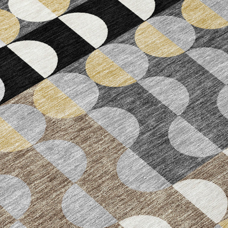 Close-up of rug surface with interlocking black, gray, white, and gold ovals