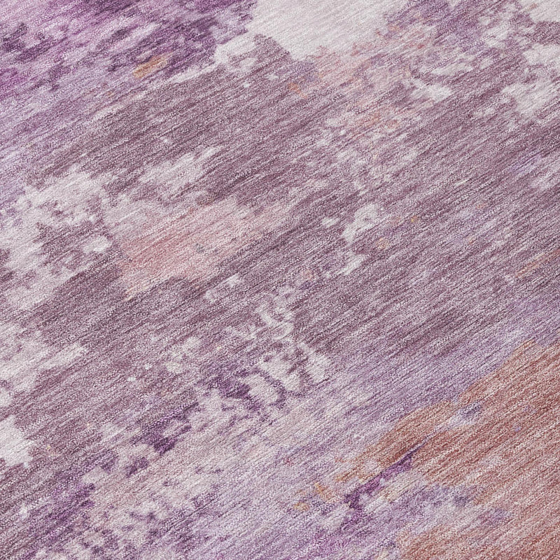 Close-up of abstract area rug texture in plum and purple with taupe distressed areas