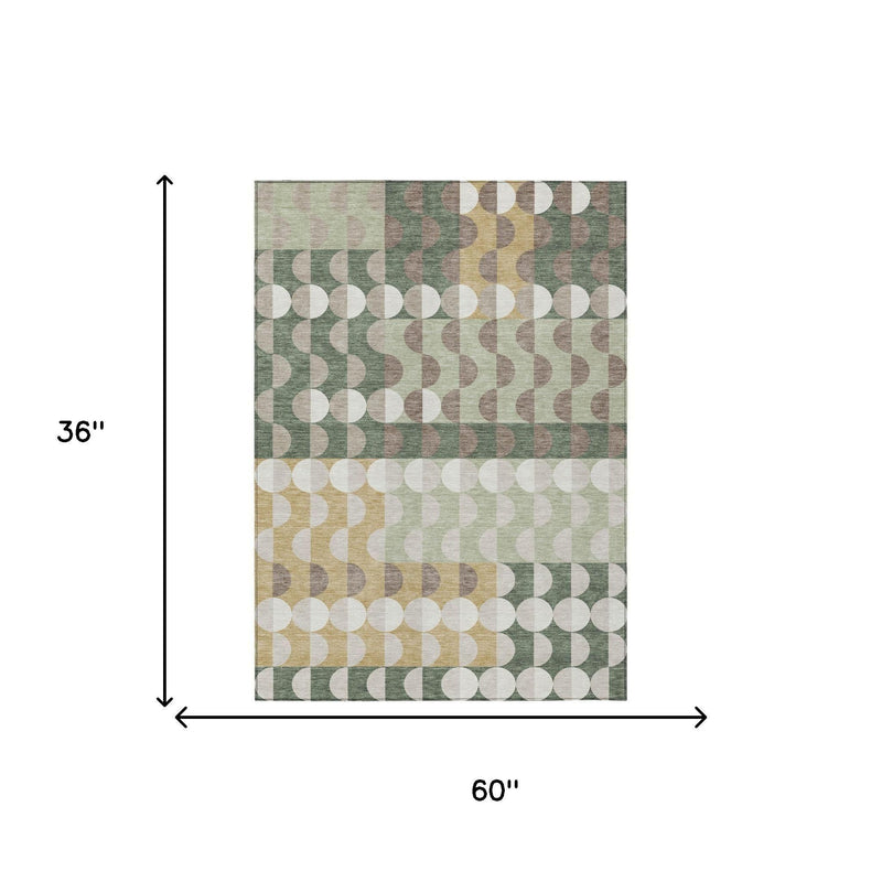 Rectangular area rug in green and ivory with geometric circles; 60 in x 36 in