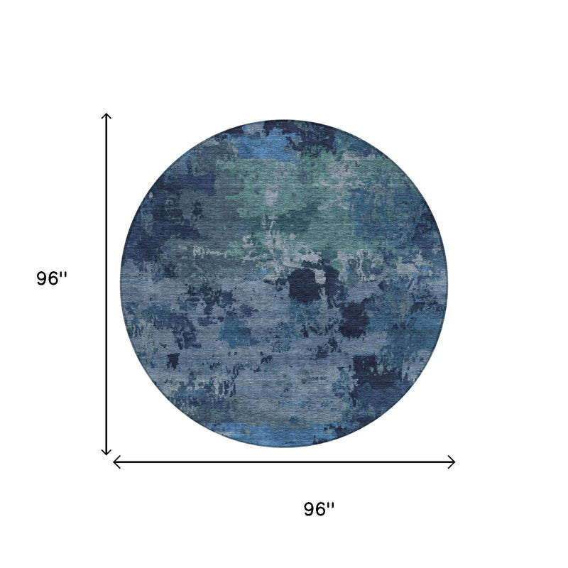 Round blue and navy abstract wash area rug with flat, mottled pattern