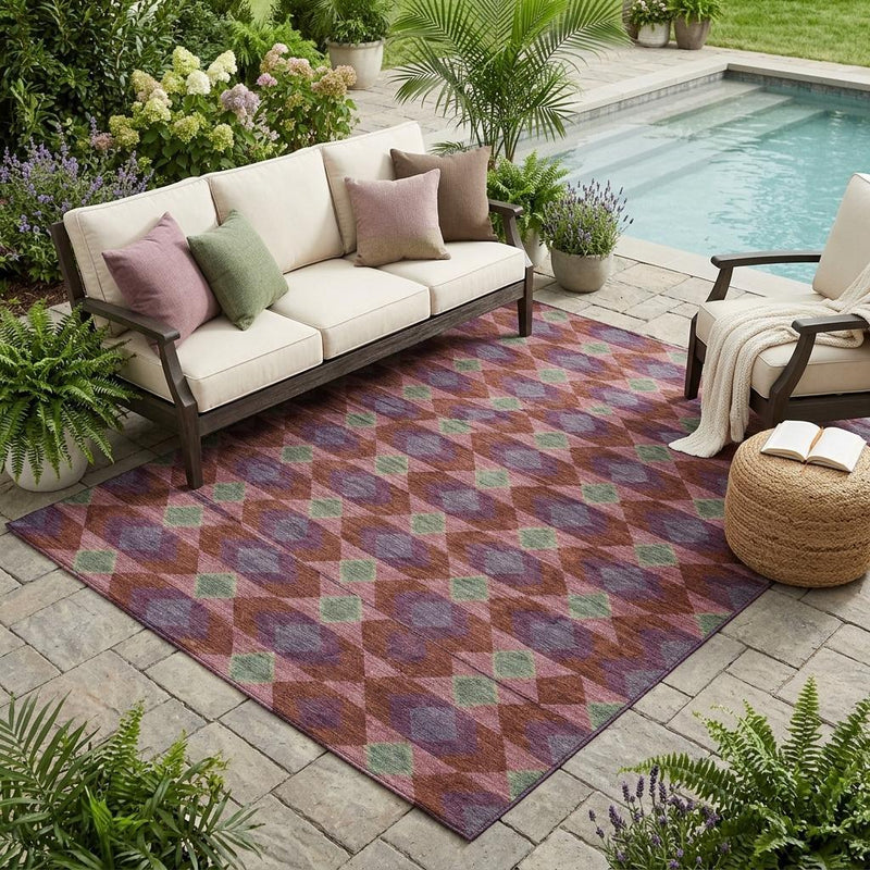 Geometric outdoor area rug with burgundy, gray, purple, and green diamond pattern on patio