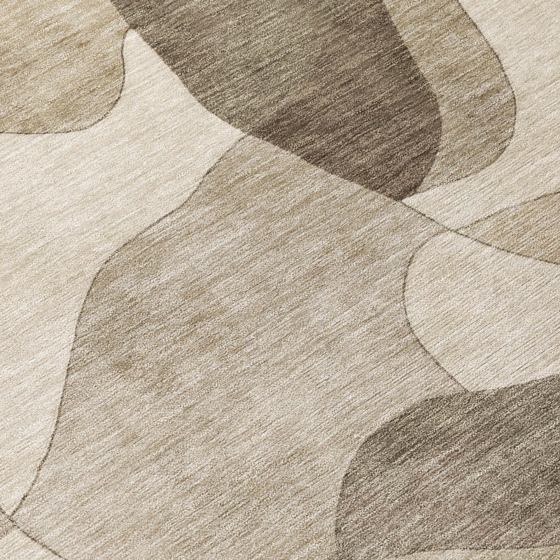 Abstract geometric area rug in beige, taupe, and dark gray with textured surface