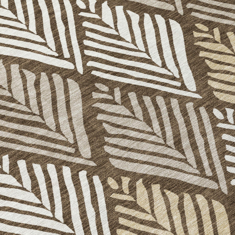Close-up of round rug pattern: dark brown and cream leaf geometry