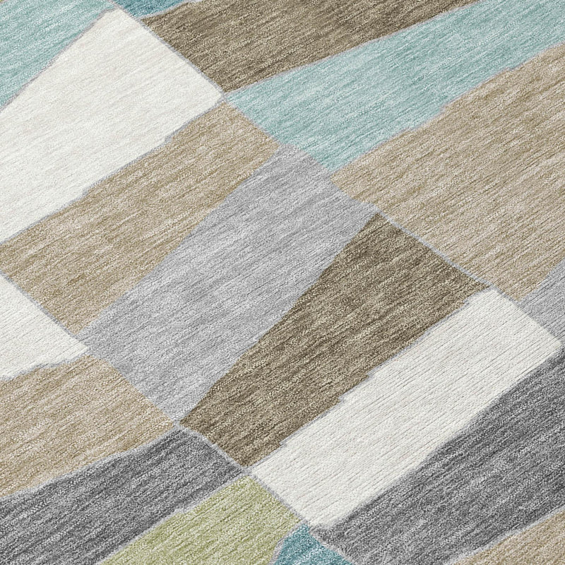 Geometric area rug close-up: teal, beige, gray, and white block patchwork