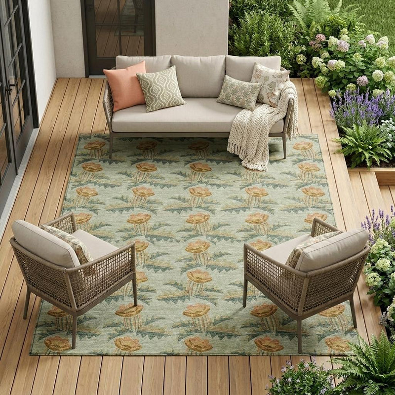 Floral area rug on patio floor with sage green tulip motif and patterned border