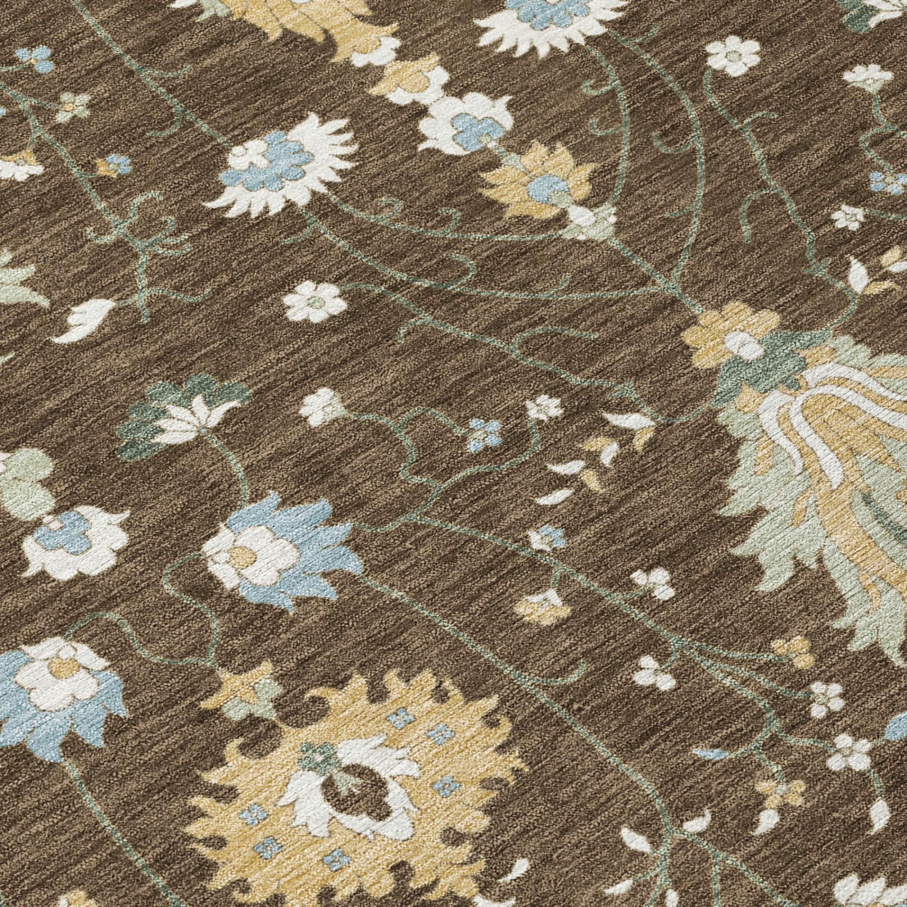 Close-up of brown indoor outdoor rug with ornate floral vine pattern in cream and blue