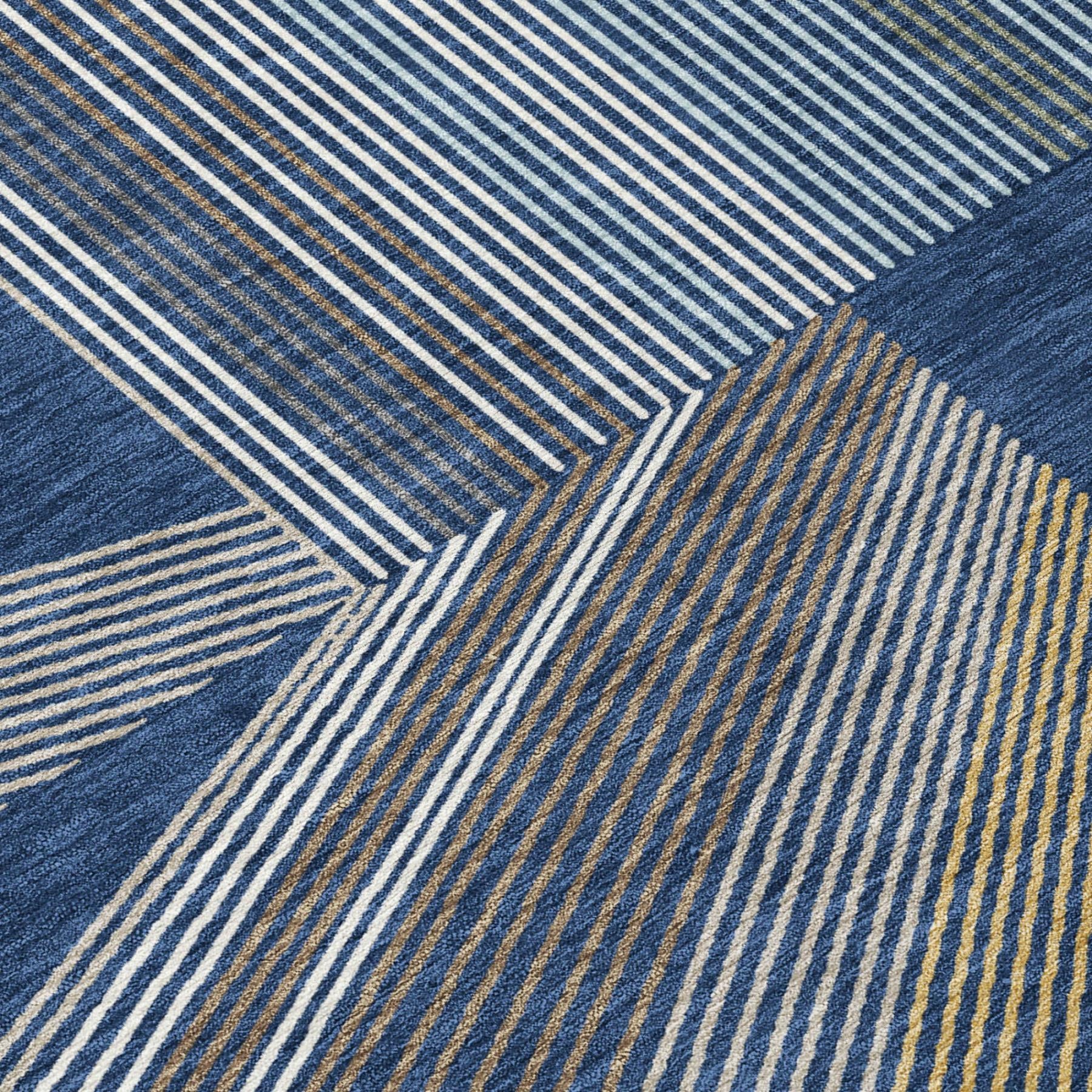 Blue geometric area rug close-up with navy, cream, and gold striped pattern