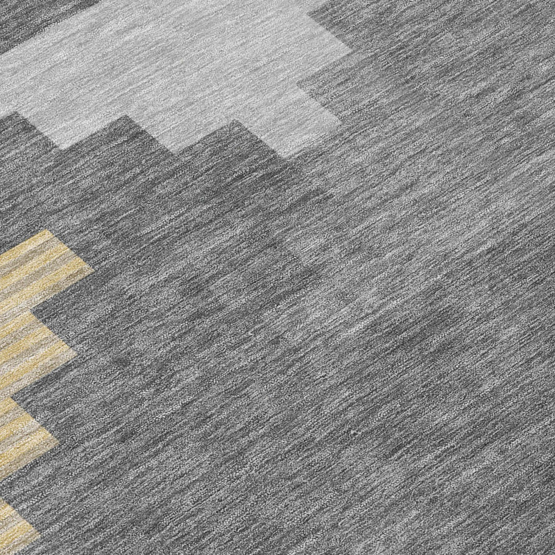 Gray geometric rug surface with yellow and beige block accents, fine textured weave