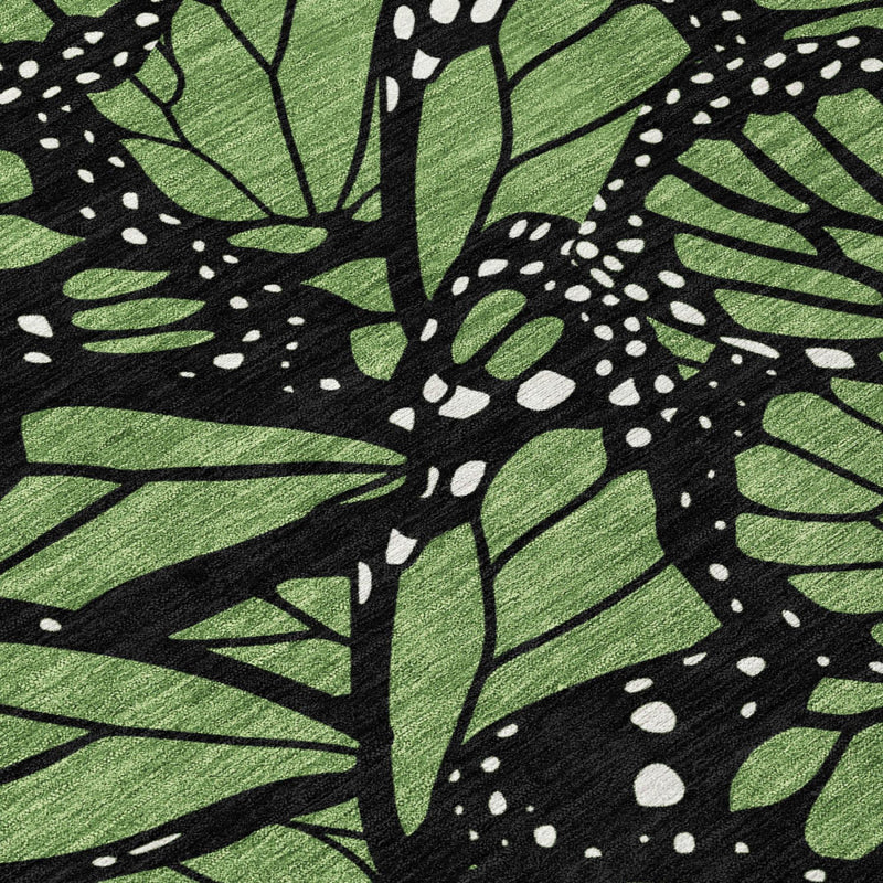 Green and black butterfly leaf animal print area rug close-up with dotted highlights