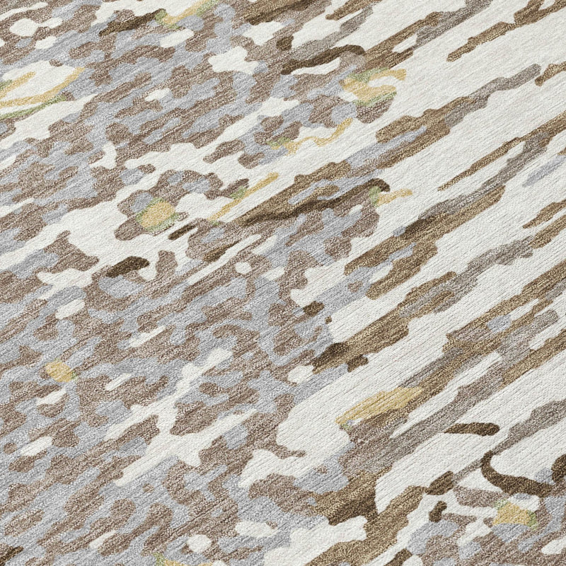 Close-up of ivory, gray, and silver abstract rug texture with scattered brush strokes.
